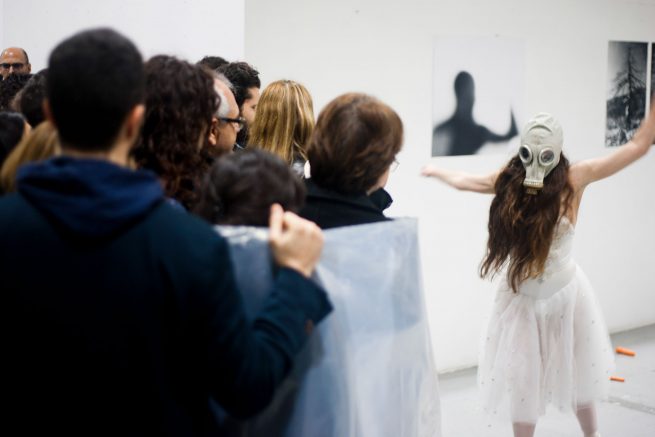 from the work breathe. performers roll the audience with cellophane and the ballerina with the full phase mask dances