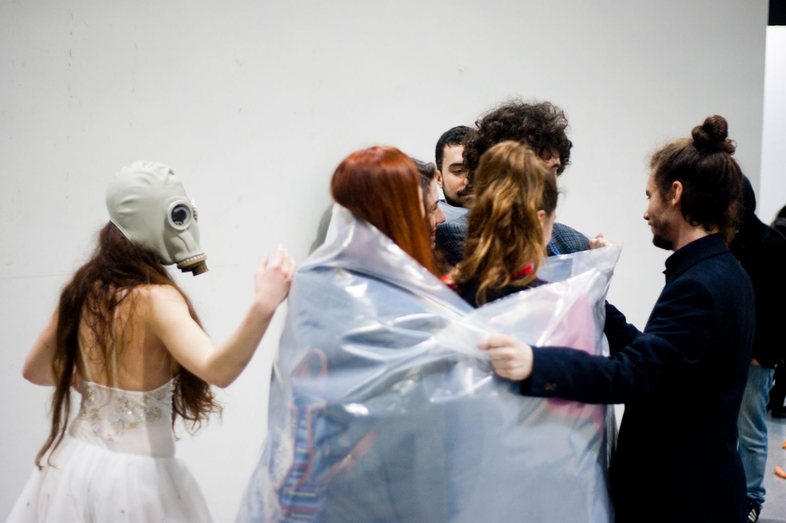 from the work breathe. performers roll the audience with cellophane