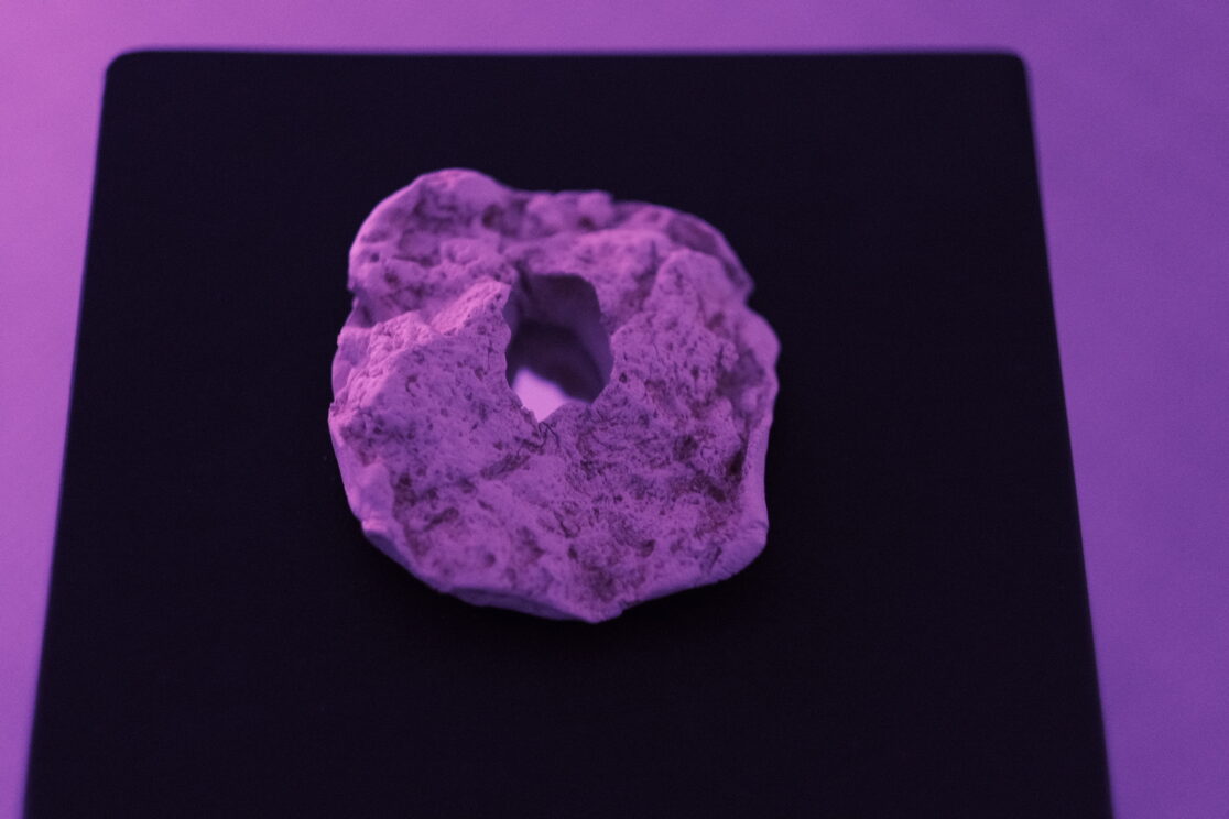 detail of the artwork. Clay that has a whole with a mirror inside