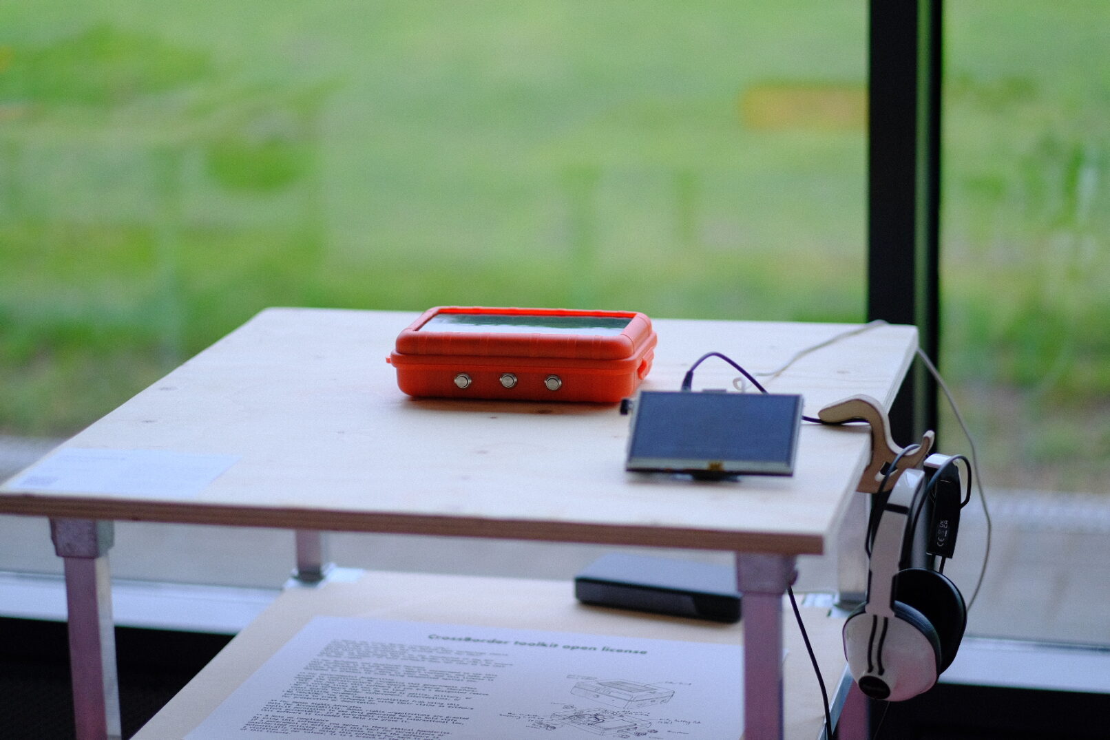 a table with a orange solar device and a small screen