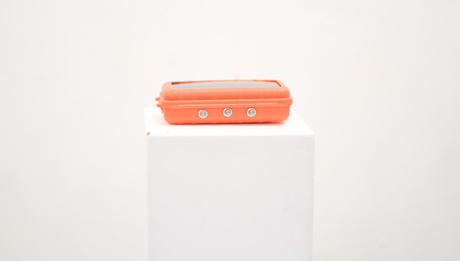 small dimension orange box that has 3 buttons and a solar panel